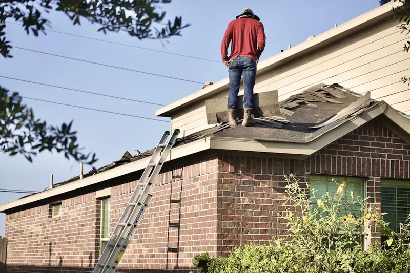 Professional roofer working on a residential roof in North Cohasset